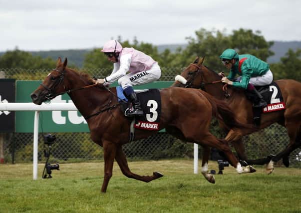 Sultanina (left) ridden by William Buick wins the Markel Insurance Nassau stakes.