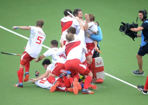 England's players celebrate winning the bronze medal game against New Zealand.