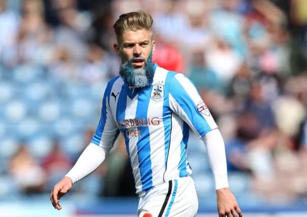 Adam Clayton with a blue and white beard