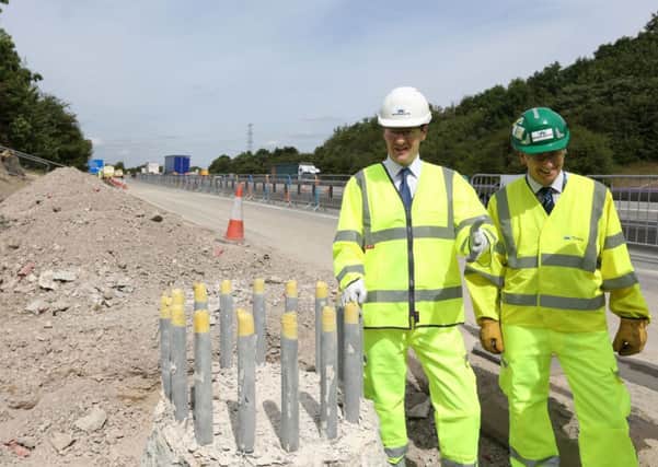 George Osborne with Highways Agency project manager David Pilsworth during a visit to roadworks on the M1 near Wakefield