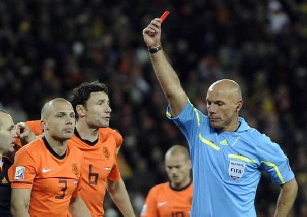 Referee Howard Webb of England, right, shows the red card to Netherlands' John Heitinga, left, during the World Cup final soccer match between the Netherlands and Spain in 2010.