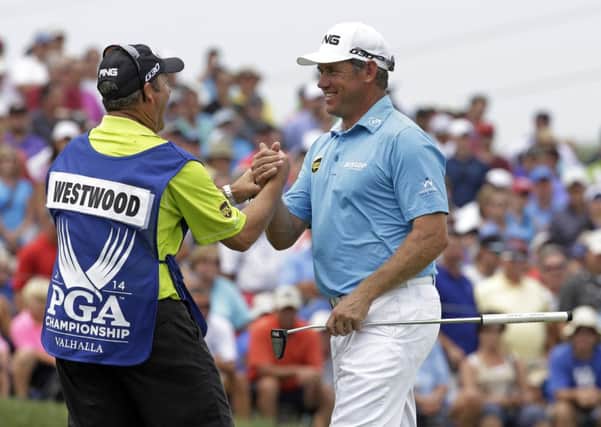 Lee Westwood, of England, right, shakes hand with his caddie Billy Foster after firing a 6-under par first round of the PGA Championship.