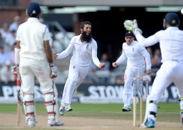 England's Moeen Ali (centre) celebrates taking the wicket of India's Cheteshwar Pujara (left), during the Fourth Investec Test at Emirates Old Trafford, Manchester.