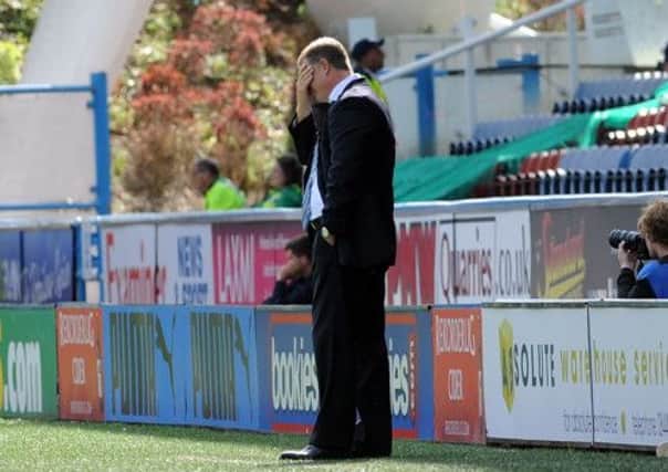 Huddersfield manager Mark Robins with his head in his hands. (Picture: Simon Hulme)