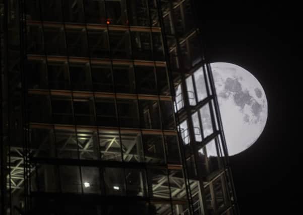 A view of the 'supermoon', or perigee moon, rising behind The Shard building in  London. PIC: PA