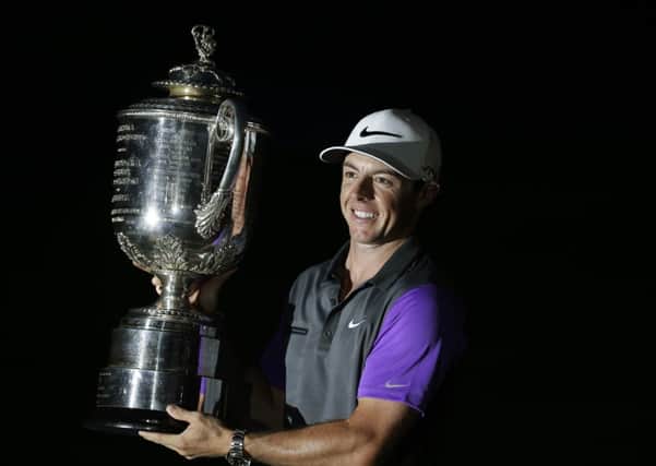 Rory McIlroy holds up the Wanamaker Trophy.