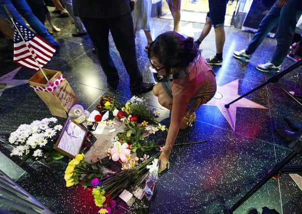 Flowers are placed in memory of Robin Williams on his Walk of Fame star in the Hollywood.