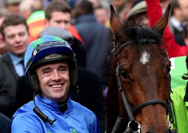 Jockey Ruby Walsh with Hurricane Fly after winning the Stan James Champion Hurdle Challenge Trophy at Cheltenham in 2013.