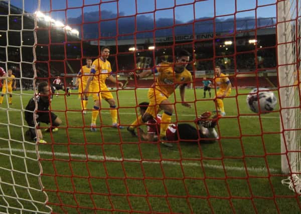 Andy Butler scores for Sheffield United in their 2-1 first-round win over Mansfield Town. The Blades face West Ham next.