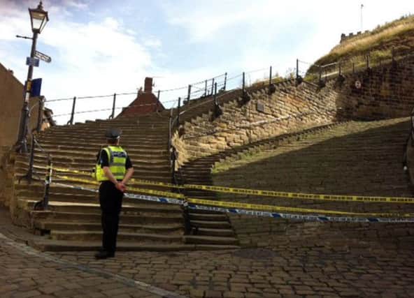 Police remain at the scene of an incident in Whitby where a woman was found this morning with serious head injuries. The bottom of the famous 199 steps leading to Whitby Abbey and St Mary's Church are currently cordoned off. The woman was airlifted to James Cook Hospital in Middlesbrough with life-threatening injuries. The cause of the injuries is currently unknown

14 August 2014
