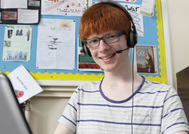 Aidan Clancy wearing the headset and microphone he used to take his A levels at Ripon Grammar School