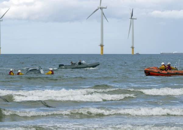 The crew rescuing one of two cars.
Photo: Dave Cocks/RNLI/PA Wire