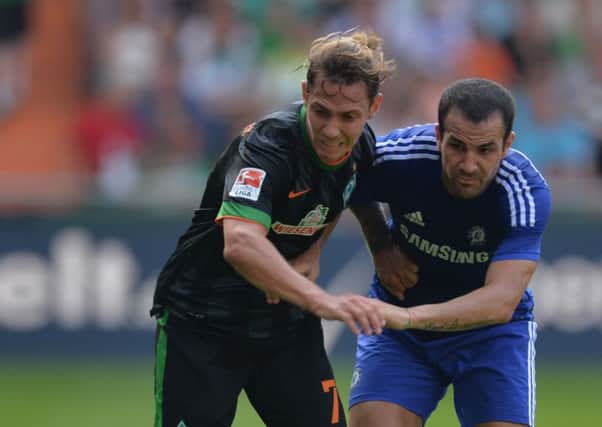 Bremen's Ludovic Obraniak, left, challenges with Chelsea's Cesc Fabregas. (AP Photo. Carmen Jaspersen)