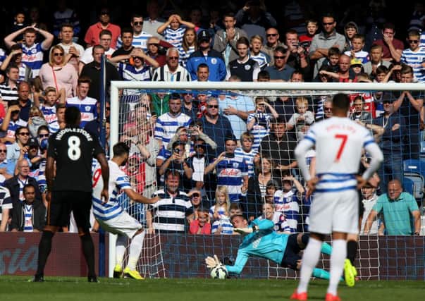 Queens Park Rangers' Charlie Austin (second left) watches as Hull City's goalkeeper Allan McGregor saves his penalty.