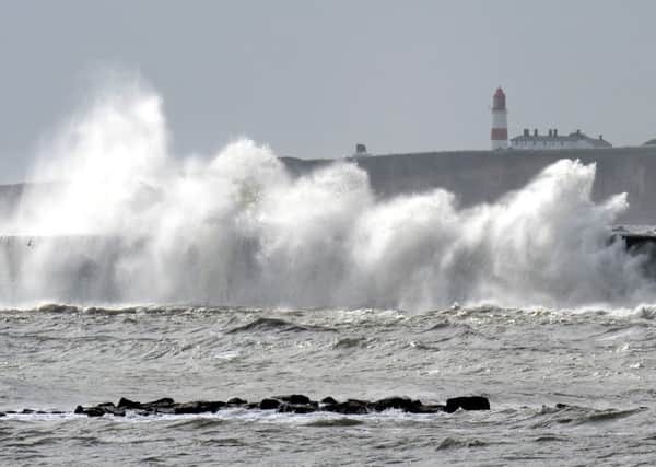 Waves crash against the promenade in Marsden near the Souter Lighthouse as two weeks of wet, windy and cool weather is likely to signal the end of summer, forecasters have warned. PIC: PA