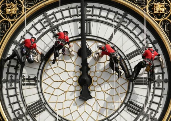 A specialist technical abseil team clean and inspect one of the four faces of the Great Clock, otherwise known as Big Ben, at the Houses of Parliament, in central London, as they undertake essential maintenance and cleaning of the four faces. PIC: PA