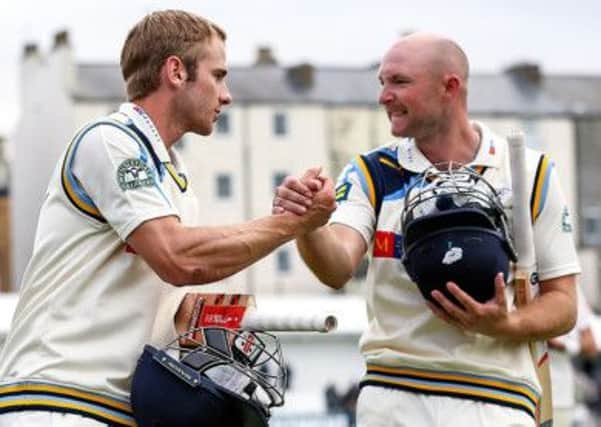 Kane Williamson, left, and a jubilant Adam Lyth leave the field yesterday after steering Yorkshire to victory over Sussex at Scarborough (Picture: Alex Whitehead/SWPIX.COM).