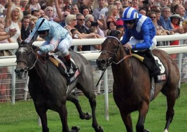 Paul Hanagan on Mukhadram, pictured right, edges in front of Grandeur, ridden by Frankie Dettori, to win the feature race at York on  July 27, 2013