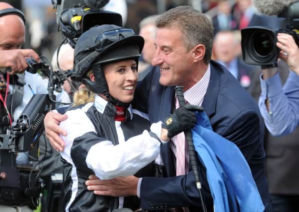 Jockey Amy Ryan is congratulated by her father Kevin Ryan.