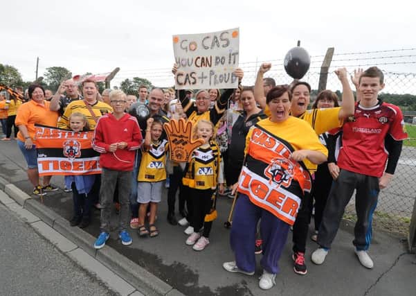 Castleford Tigers fans wave goodbye as the squad heads to Wembley. PIC: James Hardisty