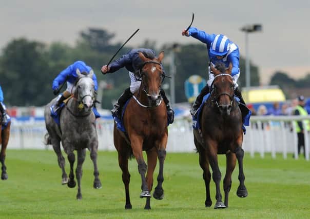 Tapestry ridden by Ryan Moore (centre) beats Taghrooda ridden by Paul Hanagan (right) to win the Darley Yorkshire Oaks.