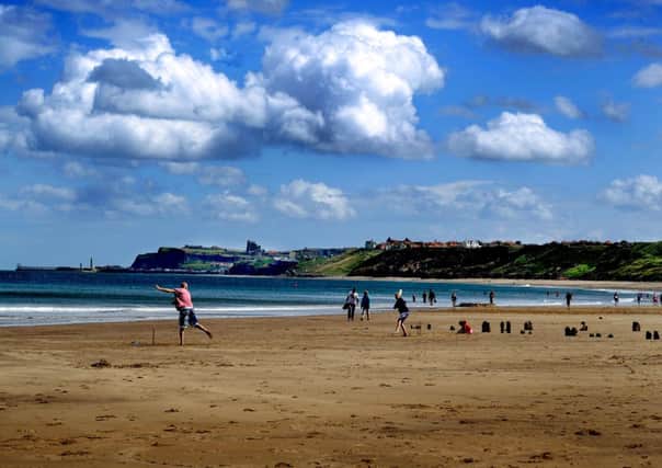 A family plays cricket on the beach at Sandsend. PIC: James Hardisty