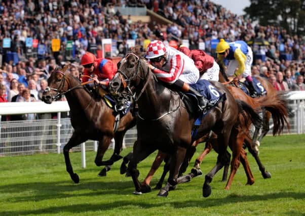 Sole Power ridden by Richard Hughes  (number 6) wins the Coolmore Nunthorpe Stakes.