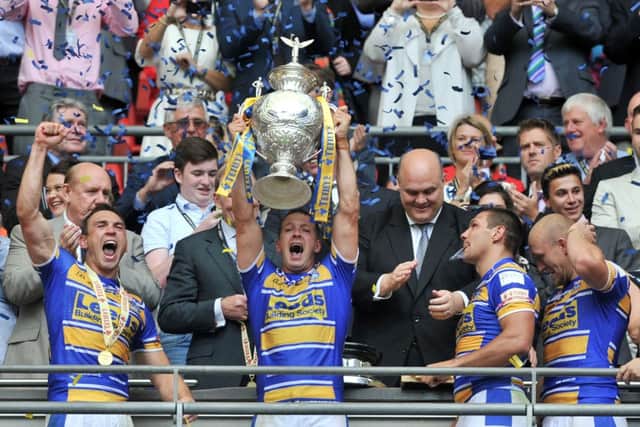 Danny McGuire lifts the Challenge Cup trophy