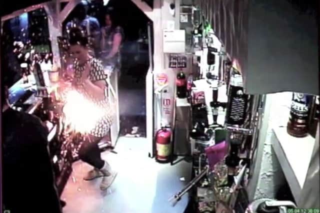 Picture shows Laura Baty, 18 who narrowly missed being engulfed in flames whilst working behind the bar of the Buck Hotel as colleague Stewart Paterson, 21 charged his E-Cigarette. 
CCTV footage shows it exploding.
See copy RPYCIG
CCTV footage has caught the moment a ball of fire narrowly missed a barmaid's head when an e-cigarette exploded and wrecked her dress.Laura Baty, 18, was serving a punter when she heard a massive bang and saw fire coming towards her. Before she had time to think she felt the heat on her arm and started running away. She said: "I was about to give somebody their change and I heard the bang. I could see the fire coming at me and I felt the heat as I ran away."I started crying hysterically and my arm was all black. My dress caught on fire as I ran away and I just didn't know what was happening. "A customer came and took me in to the bathroom to calm me down. She washed down my arm which was all black and I still didn't know what had happened."Laura, who has worked at the Buck Inn Hotel