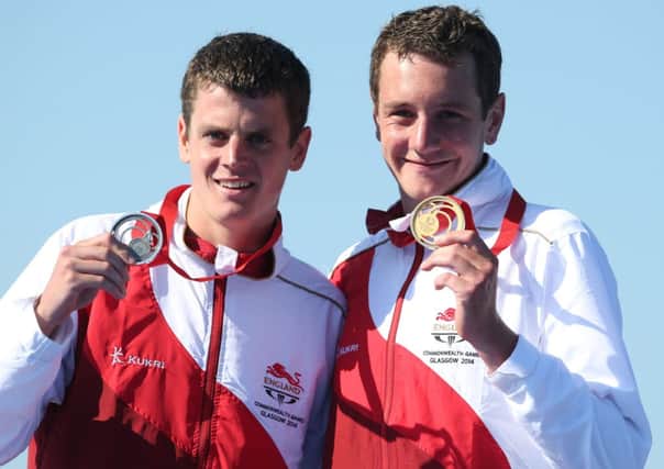 Englands Alistair Brownlee (right) with his gold medal after winning the Men's Triathlon with brother Jonathan who won silver at Strathclyde Country Park during the 2014 Commonwealth Games near Glasgow.