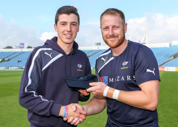 Yorkshire's Matthew Fisher receives his second team cap from captain Andrew Gale. Picture by Alex Whitehead/SWpix.com