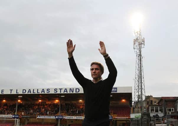 Bradford City manager Phil Parkinson applauds the home fans ahead of his side's win over Leeds United (Picture: Lynne Cameron/PA).