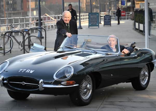 John Surtees (right) and the original test driver for the Jaguar E-Type, Norman Dewis, with the Jaguar Heritage Trust's E-Type 77RW