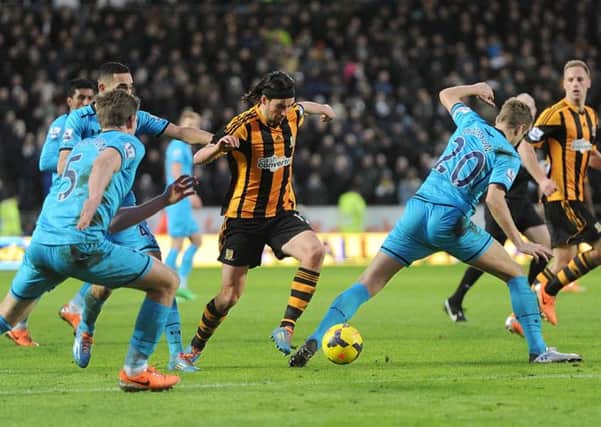Tottenham Hotspur's Jan Vertonghen (left) and Michael Dawson (right) battle for the ball with Hull City's George Boyd