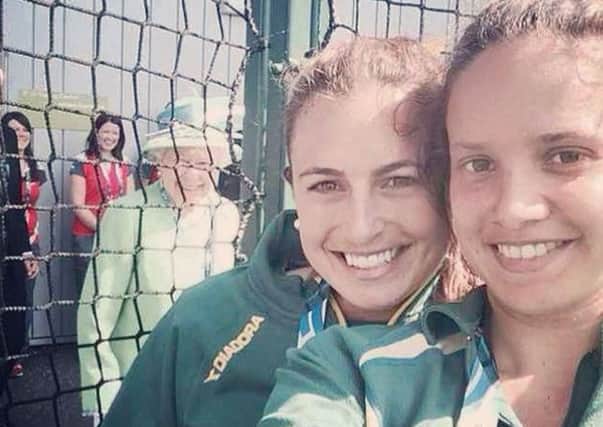 The Queen 'photo bombs' a selfie of Australian hockey players Jayde Taylor (centre) and Brooke Peris.