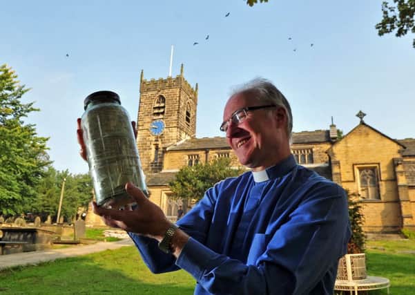 Rev Richard Steel with a Time Capsule unearthed by builders