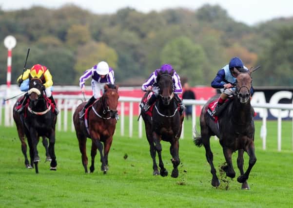 Kingston Hill ridden by Andrea Atzeni, right, wins the Racing Post Trophy at Doncaster last year.
