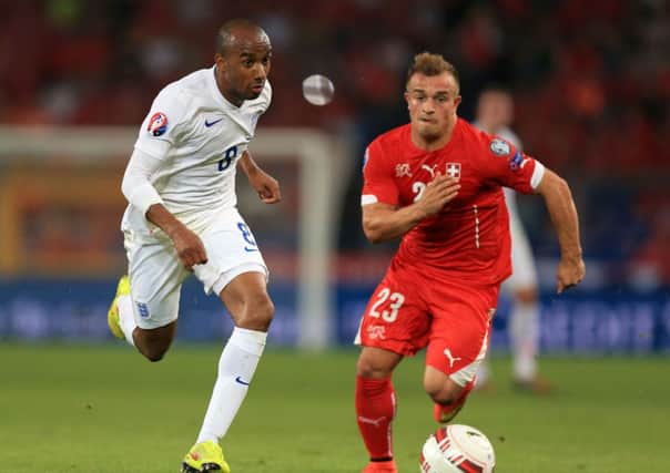 England's Fabian Delph (left) and Switzerland's Xherdan Shaqiri battle for the ball. PIC: PA