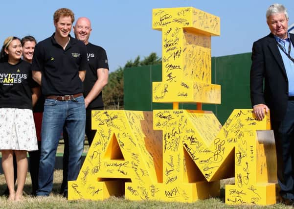 Prince Harry next to a giant Invictus Games logo signed by volunteers. Credit: Chris Jackson/PA Wire