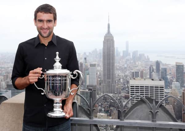 Marin Cilic, of Croatia, poses with the US Opentrophy at the top of the Rock Observation Deck at Rockefeller Center, New York (Mike Groll/AP).