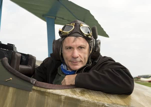 Iron Maiden front-man Bruce Dickinson sitting in the cockpit of his own replica Fokker Dr1 aircraft