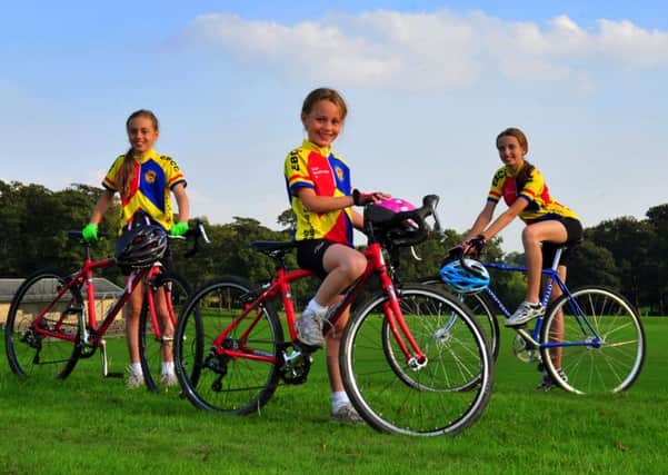 Florrie Greenhalgh, (8), centre,  with her sisters Rosa, (10),  and Lily (13) at the grass velodrome in Roundhay Park, Leeds.  Picture by Tony Johnson