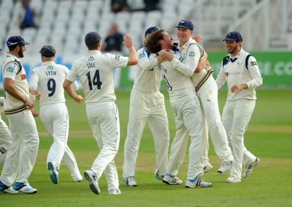Yorkshire's Ryan Sidebottom celebrates by hugging Gary Ballance after he took the catch to take the wicket of Nottinghamshire's James Taylor.