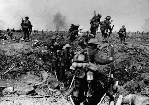 British troops negotiate a trench as they go forward in support of an attack on the village of Morval during the Battle of the Somme.