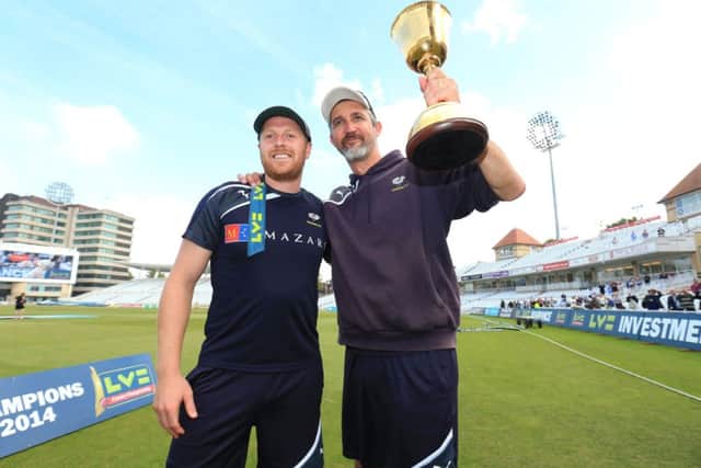 Captain Andrew Gale celebrates winning the Division One County Championship trophy along side head coach Jason Gillespie.