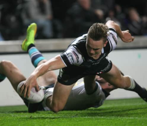 Jack Logan stretches to score, putting Hull FC ahead against Leeds.