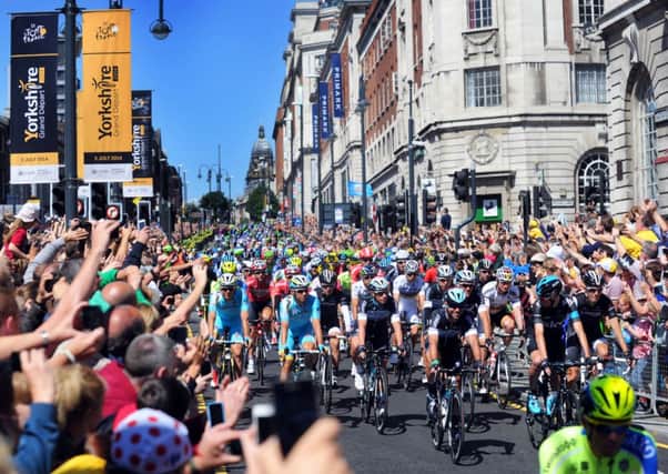 Mark Cavendish leads the cyclists down the Headrow, Leeds, at the start of the Tour De France 2014 stage one from Leeds to Harrogate. Picture by Simon Hulme.