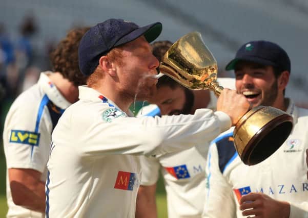 Yorkshire's Jonny Bairstow celebrates by drinking Champagne.