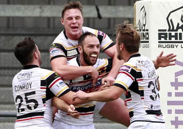 Luke Gale is mobbed after scoring his fourth and match winning try for Bradford.