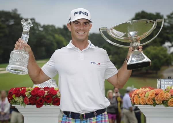 Bill Horschel poses with both trophies after winning the Tour Championship golf tournament and The FedEX Cup in Atlanta.